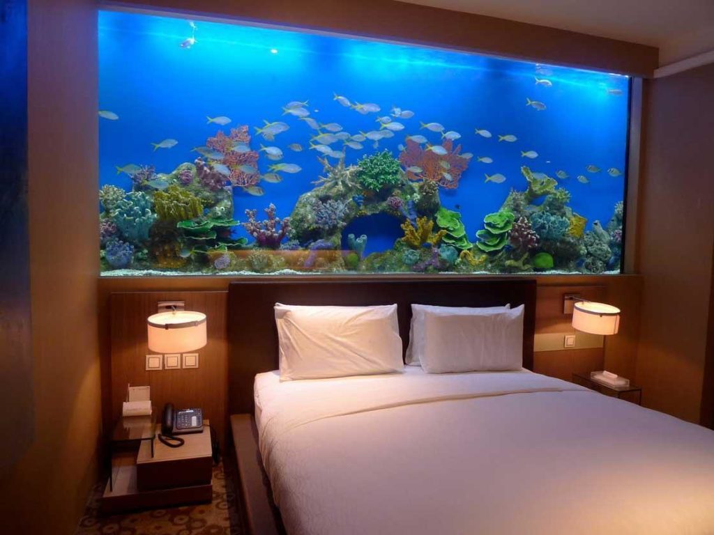 gorgeous-decorating-interior-design-with-aquarium-in-bedroom-above-headboard-also-white-bedding-set-plus-wall-lighting